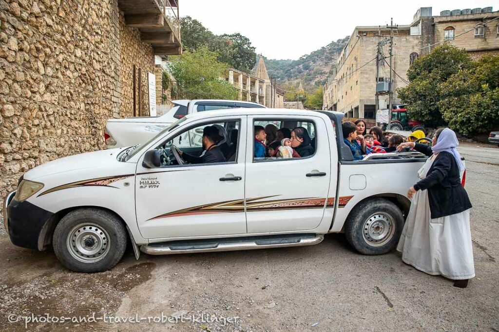 A pick up truck is heavy loaded with Yezidie children in Lalish Valley