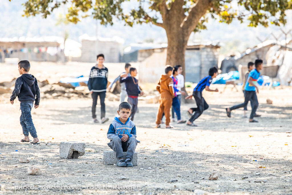 A disabled boy watching boys playing soccer in Kurdistane