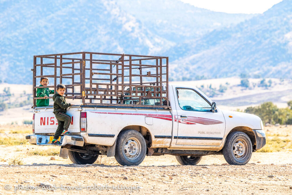 Two boys on the back of a pick up truck in Kurdistane, Irak