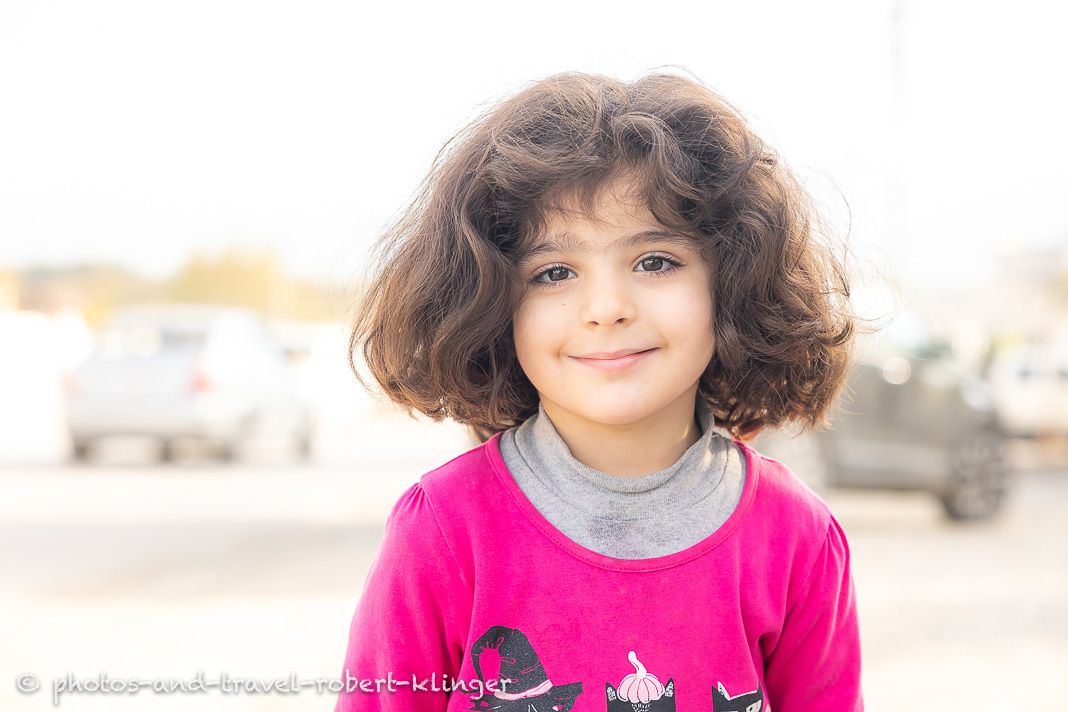 A nice little kurdish girl smiling into the camera