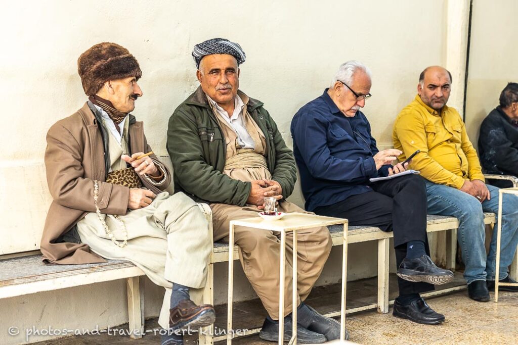 4 man are having a conversation inside a tearoom in Erbil, Kurdistan
