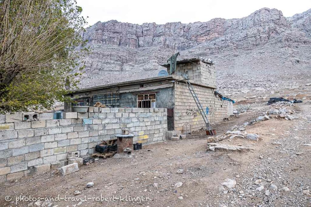 A house in a kurdish village at lake Dukan, steep mountains in the background