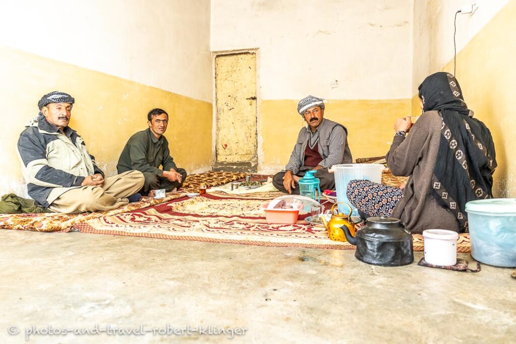 A kurdish family is having tea in their living room in a village at lake Dukan, Kurdistan