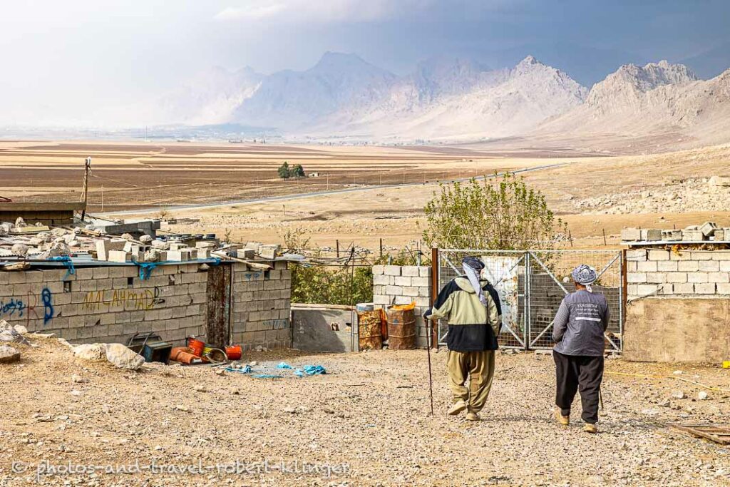 Two kurdish goat farmer are walking throuth their village at Dukan Lake