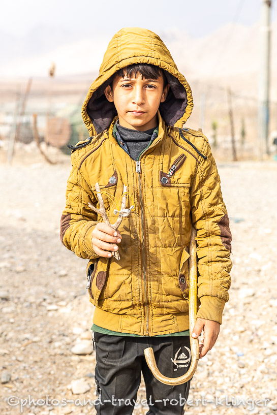 A kurdish boy with a self made slingshot