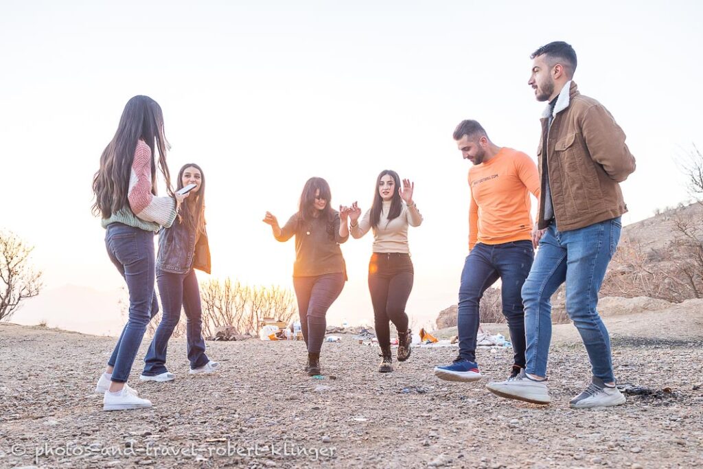 A kurdish family dancing while having a picnic in Kurdistane, Iraq