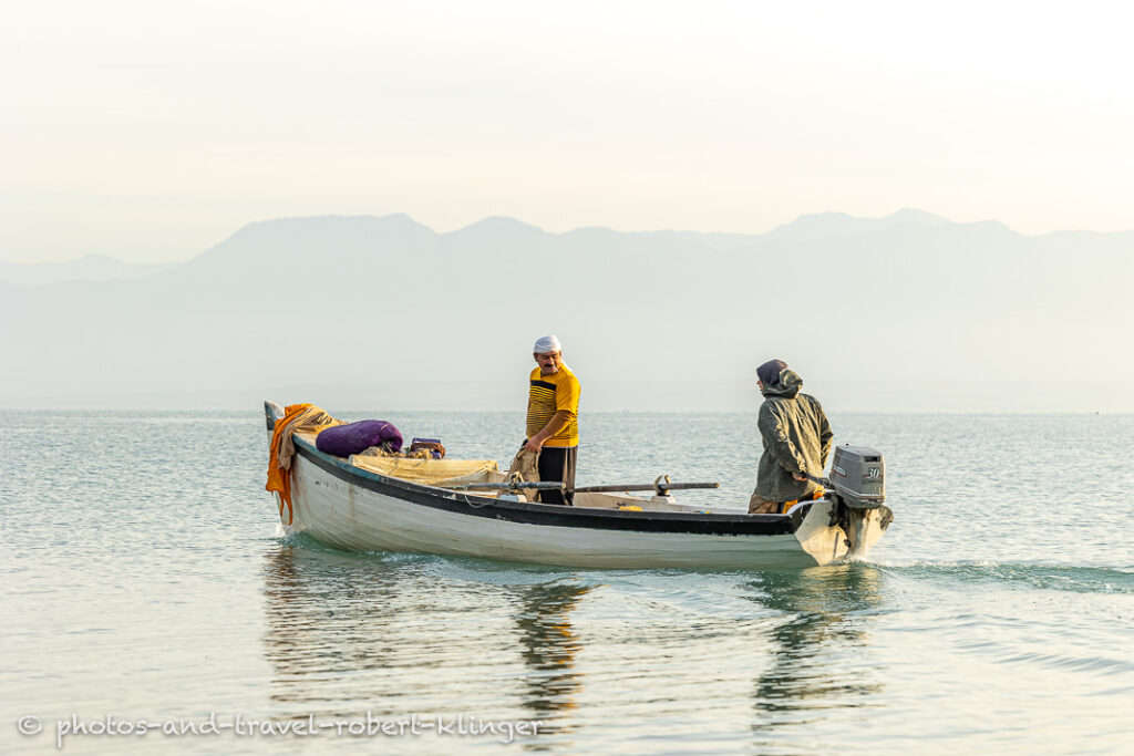 Two fishermen in there boat on Lake Dukan shortly after sunrise