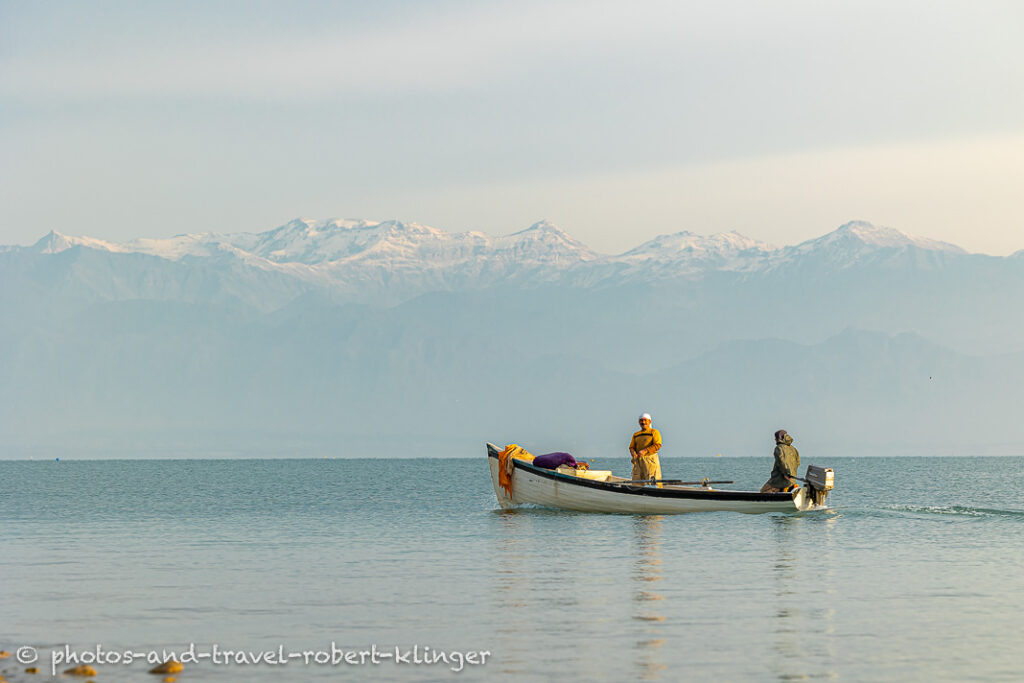 Two fishermen in there boat on Lake Dukan shortly after sunrise