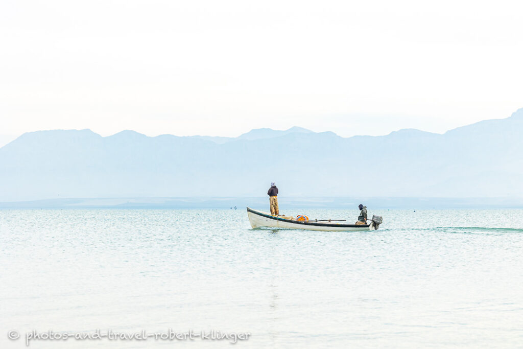 Two fishermen in there boat on Lake Dukan shortly after sunrise