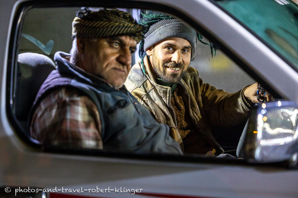 Two kurdish men sitting in a car in Kurdistane
