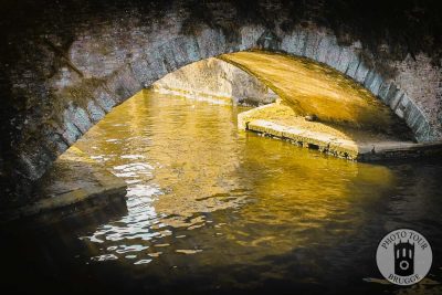 A canal archway with some lovely afternoon light in Bruges Belgium. Photo by Photo Tour Brugge.