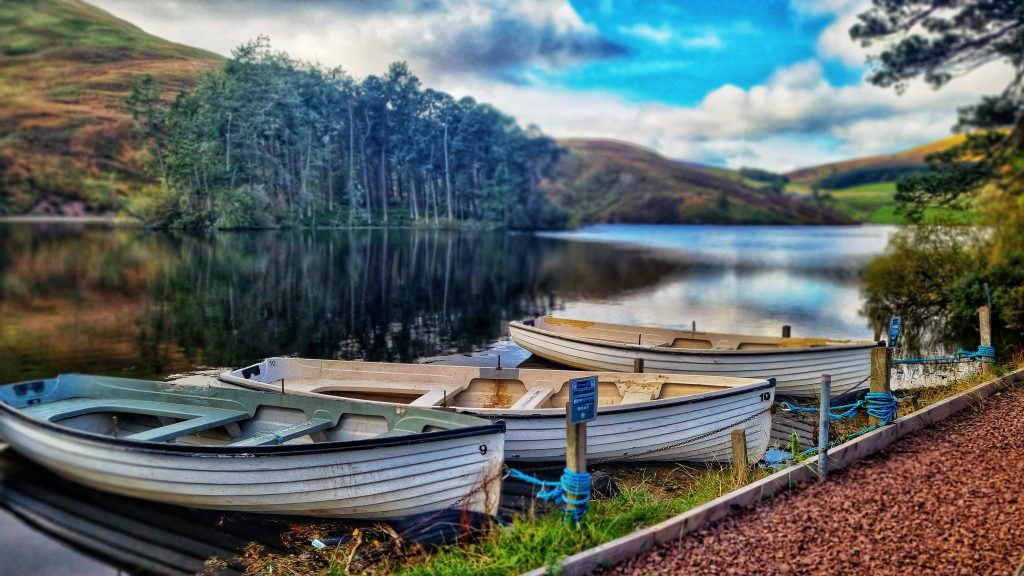 Boats on Glencorse Reservoir to help guide you on where to go when you are visiting Scotland