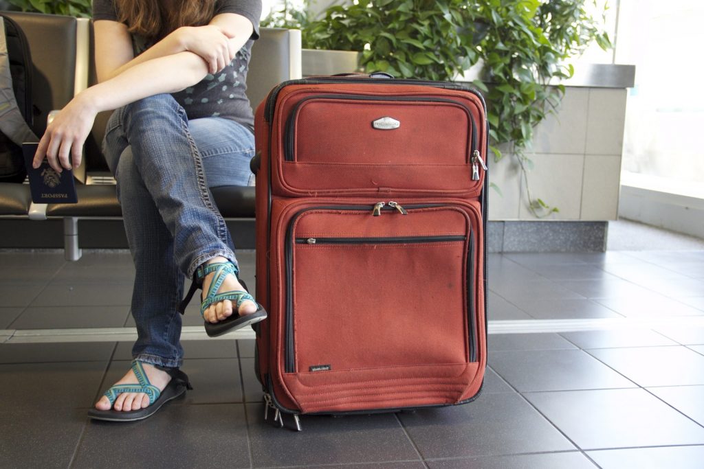 Woman with suitcase waiting for her plane.