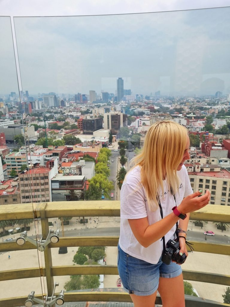 Walking tours is one of the best to meet people when travelling solo. This photo was taken of Amy when she had just finished a walking tour and made some friends. They went to check out some rooftop views recommended by the walking tour which shows the beautiful Mexico City.