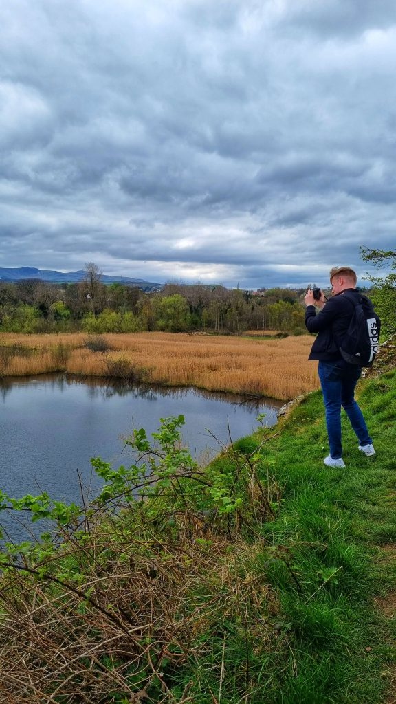 Liam taking a photo of Holyrood Park where you will find some beautiful scenery and nature.
