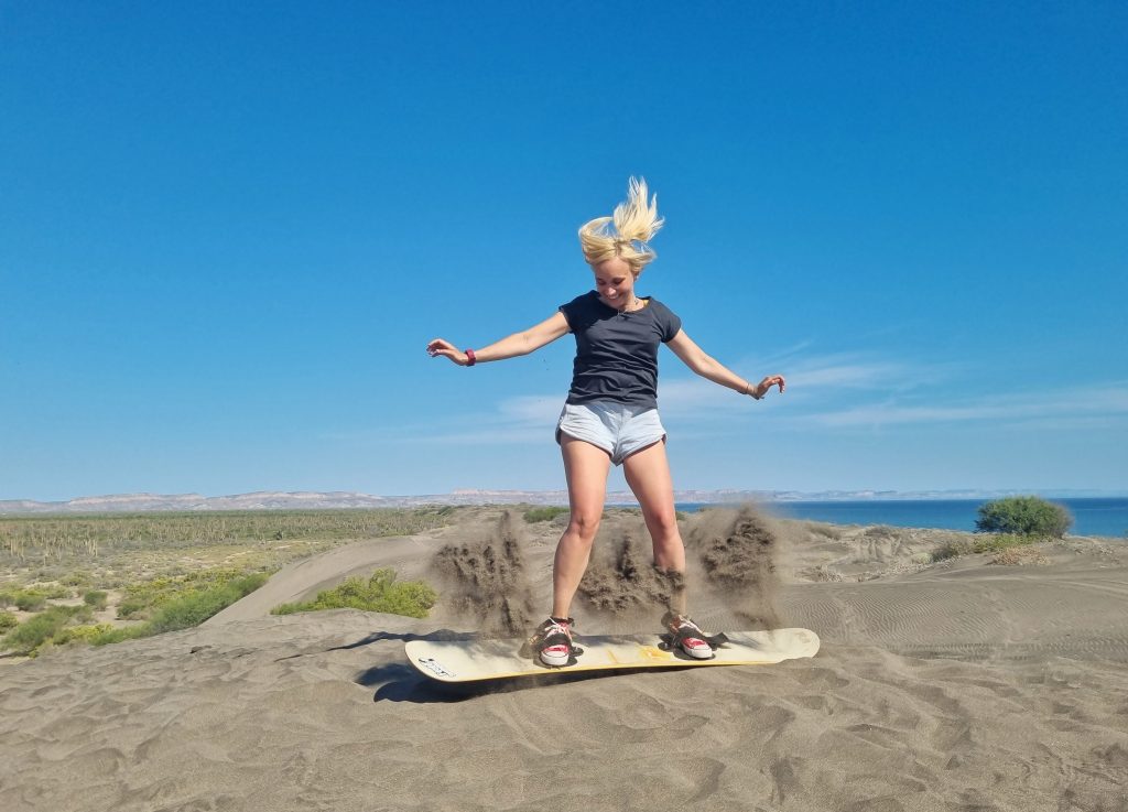 Using hobbies is one of the ways on how to meet people when travelling solo. This photo shows Amy trying sandboarding for the first time. However, it was just before this photo that she did fall and bump her head quite hard. Learning new things can have its pros and cons!