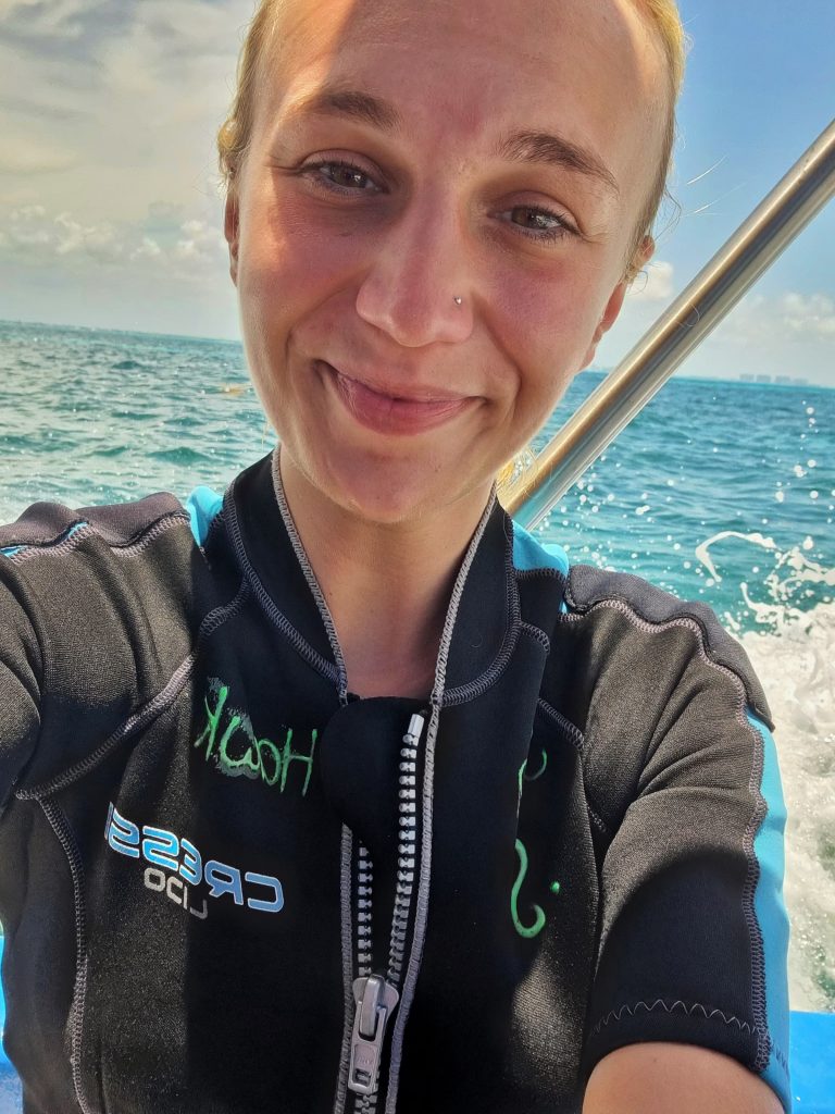 Amy taking a selfie on the boat tour just after she finished diving. You can even see lines around her face from her mask.