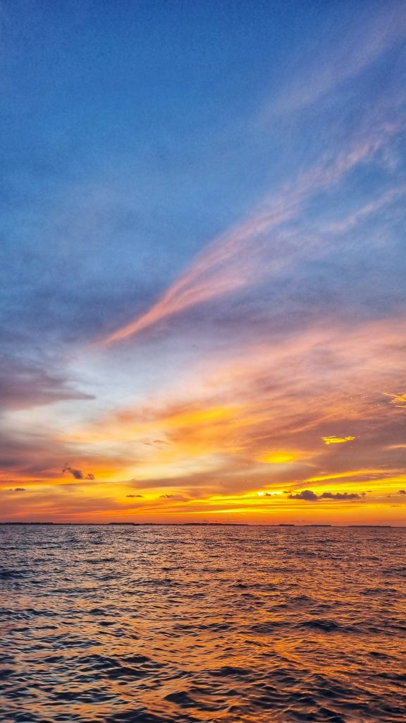 The Sunset boat tour is one of the most incredible things to do if you're spending 2 days or more in Isla Mujeres. This image shows the beautiful sunset across the water.