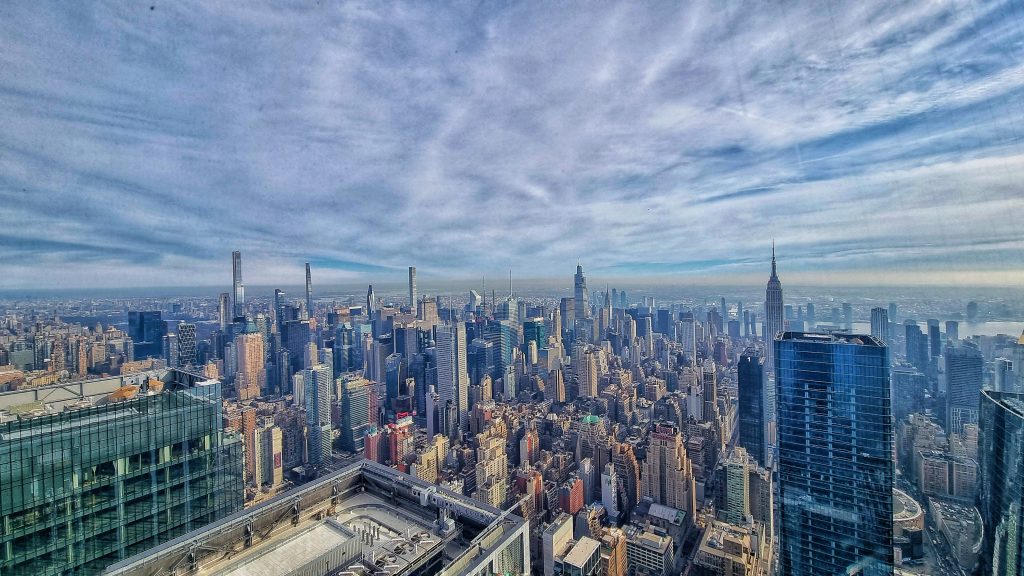 With so many different tourist attractions in New York City we've shared our top 7 that you must visit in the City. There are lots of observatories and viewpoints. This photo shows the skyline of NYC taken from The Edge.