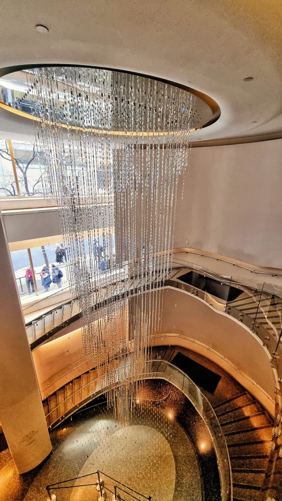 This image shows the chandelier at Top of the Rock which is a great tourist attraction to visit in New York City. You will get some incredible views from the observatory and get to enjoy the grandeur of the building too.