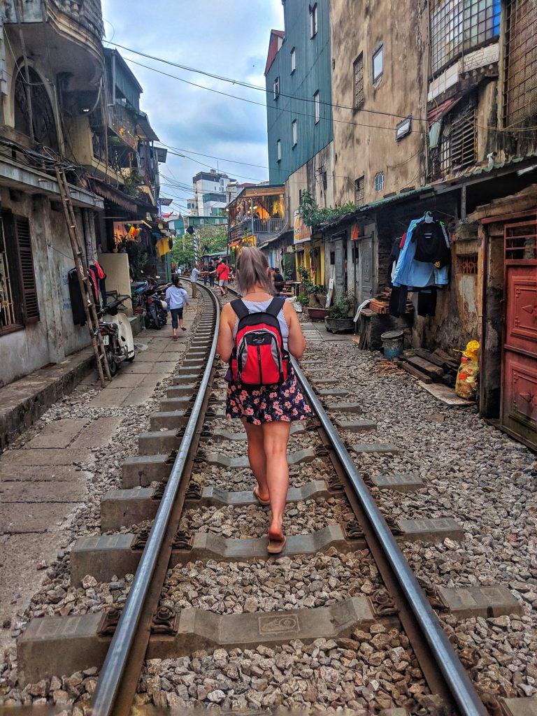 Amy walking down train street in Hanoi. One of the most incredible places to visit in Vietnam.