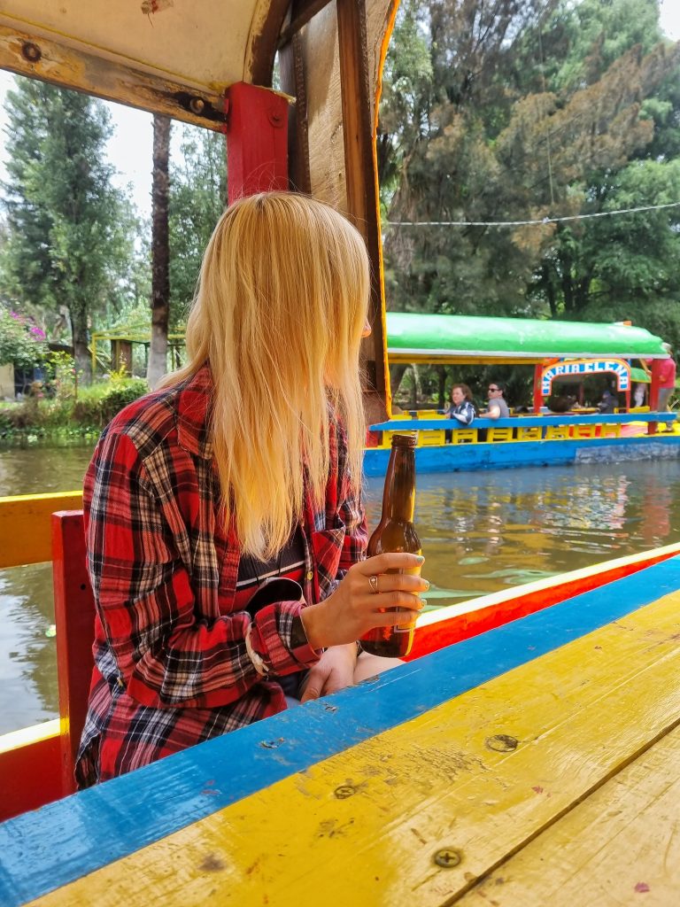 Amy enjoying a beer on the boat in Xochimilco
