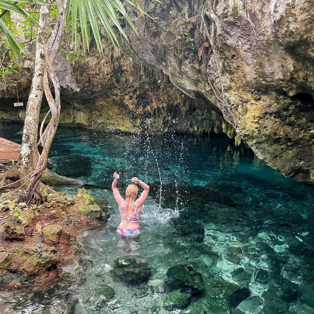 Amy playing with the water in the cenote in Mexico.