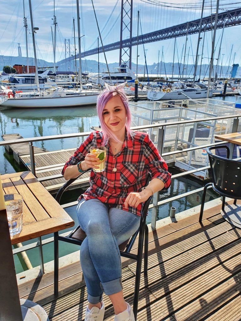 Amy enjoying a drink at the marina in Lisbon.