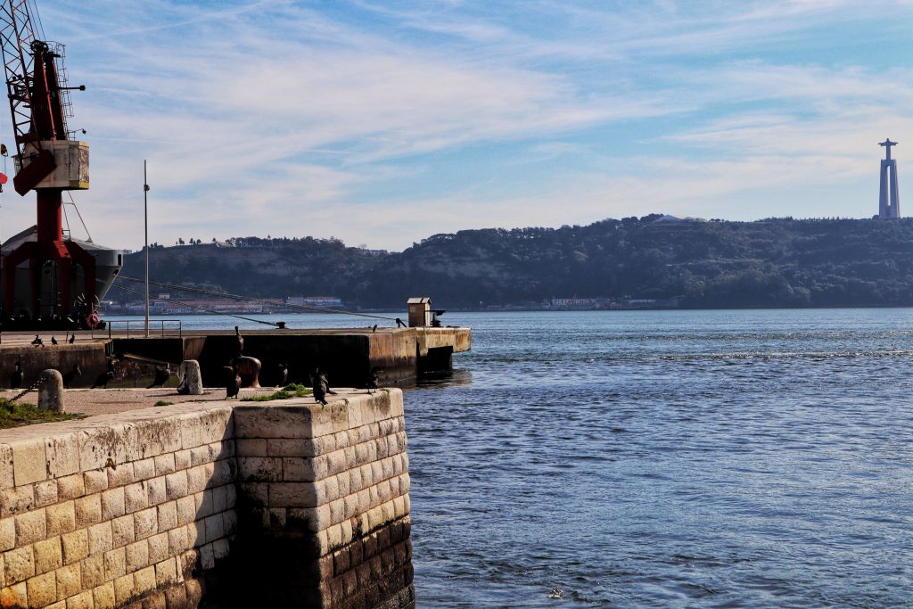 Image of the water in Lisbon with a cross visible across the water.