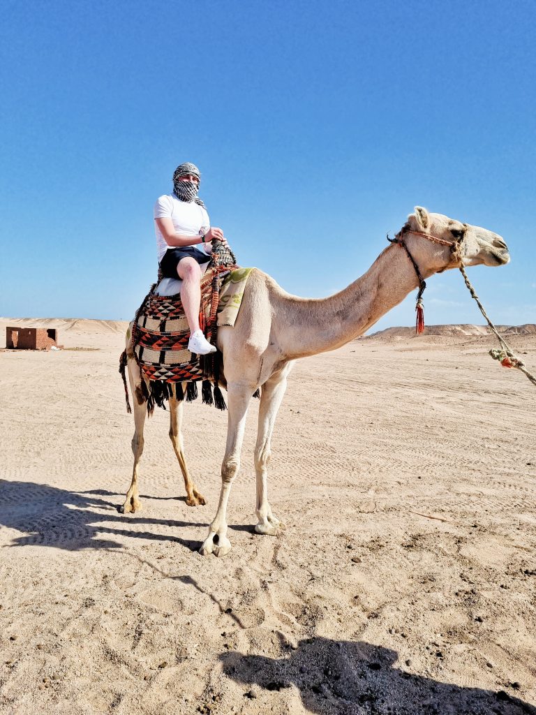 Liam riding a camel during the quad bike tour.