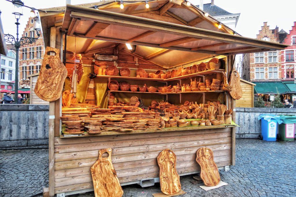 One of the unique Christmas Market stalls in Bruges, Belgium. It seels different handcrafted wood items including bowls, chopping boards and mortar and pestles.