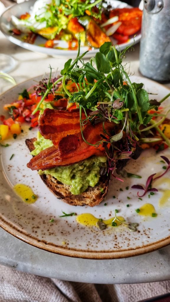 Avocado toast with bacon & rocket.