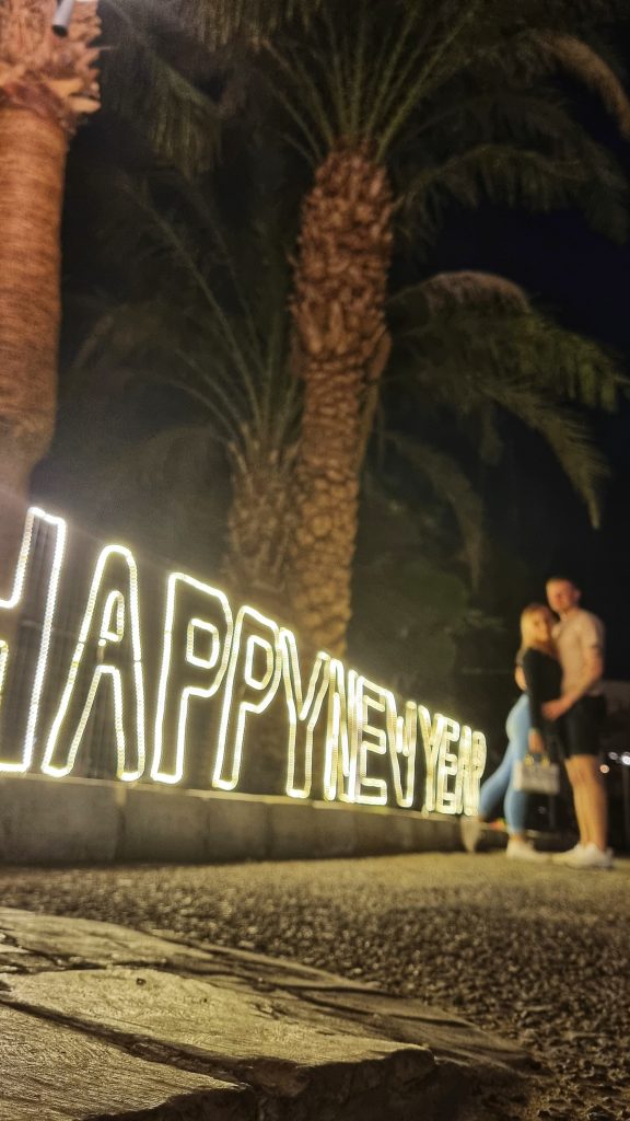 Amy & Liam posed next to the Happy New Year sign.