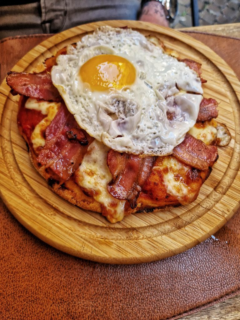 Breakfast Pizza that Liam enjoyed at Navona Street Hotel & Bistrot. The breakfast pizza includes egg, bacon and cheese.