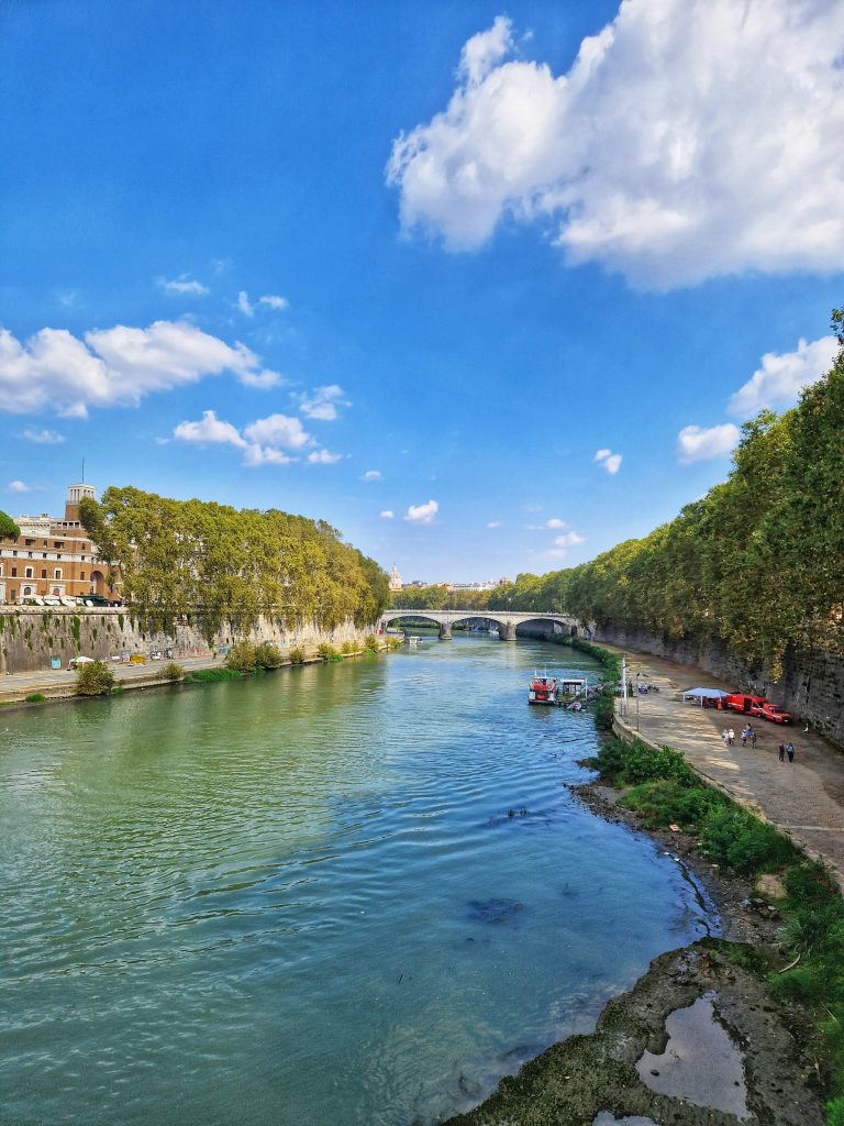 View of Tiber River where you can see the bridge in the distance.
