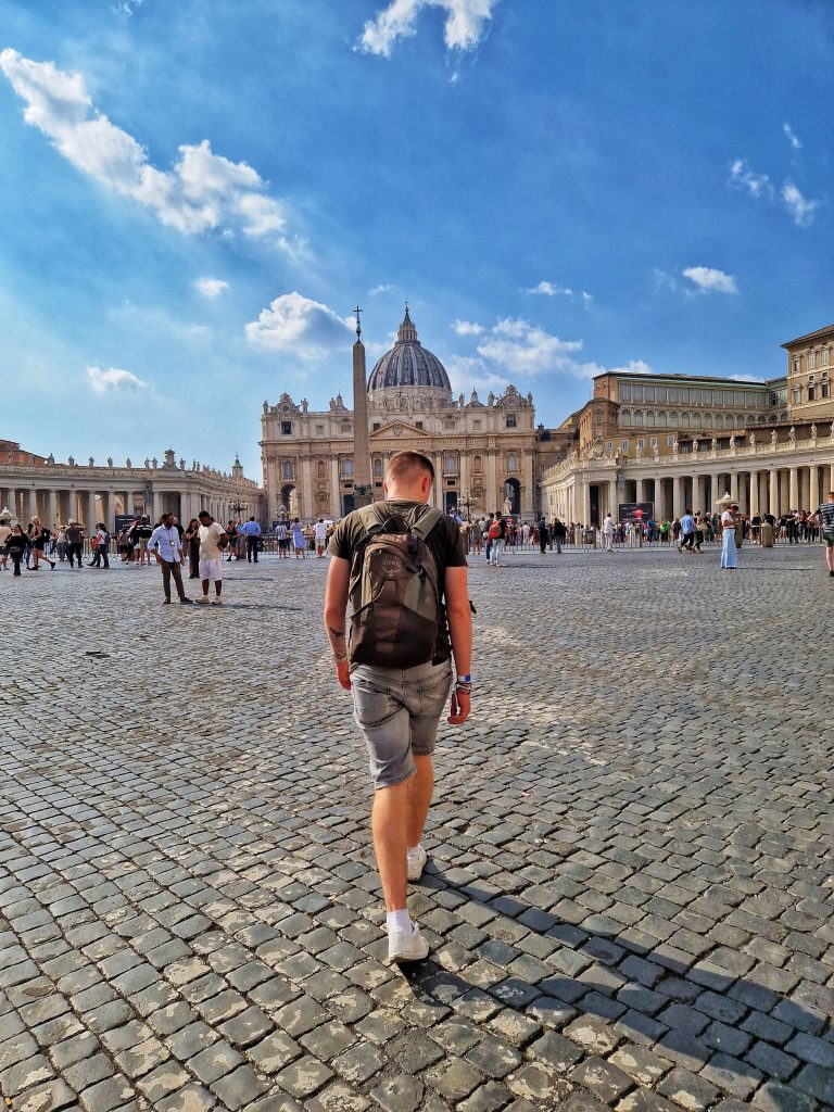 Liam walking towards St. Peter's Basilica in St. Peter's Square.