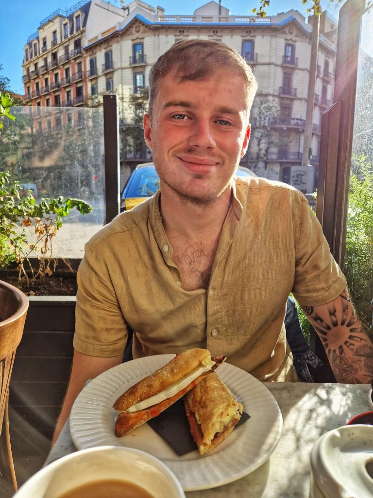 Liam enjoying a bacon, brie and crandberry sandwich at Josephine cafe.