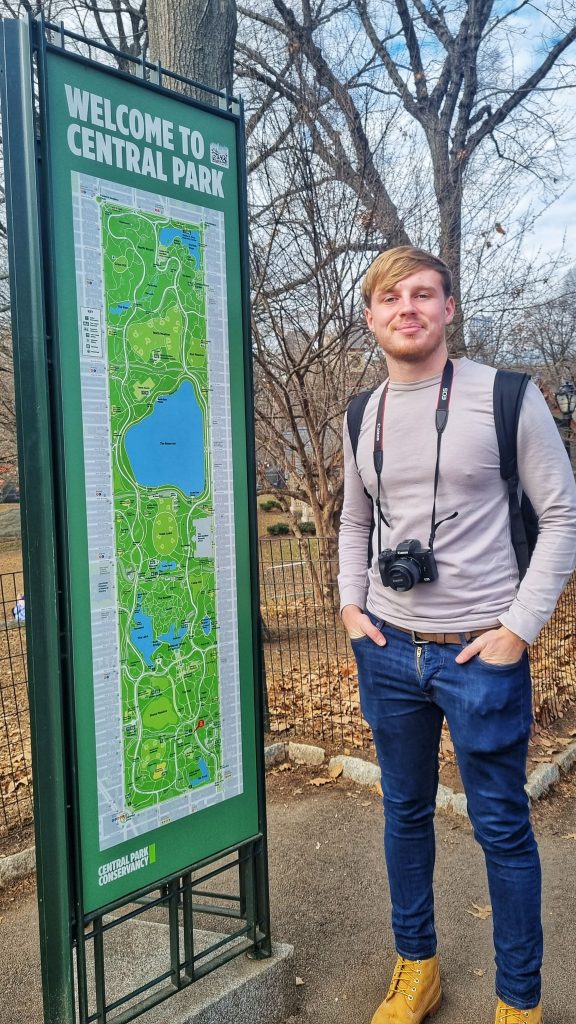 Liam standing next to the large map of Central Park