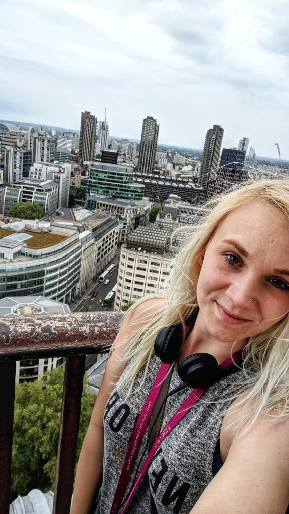 One of the easiest solo photography travel tips is by using selfies to take some photos. This image shows Amy taking a selfie at the top of St. Paul's Cathedral in London.