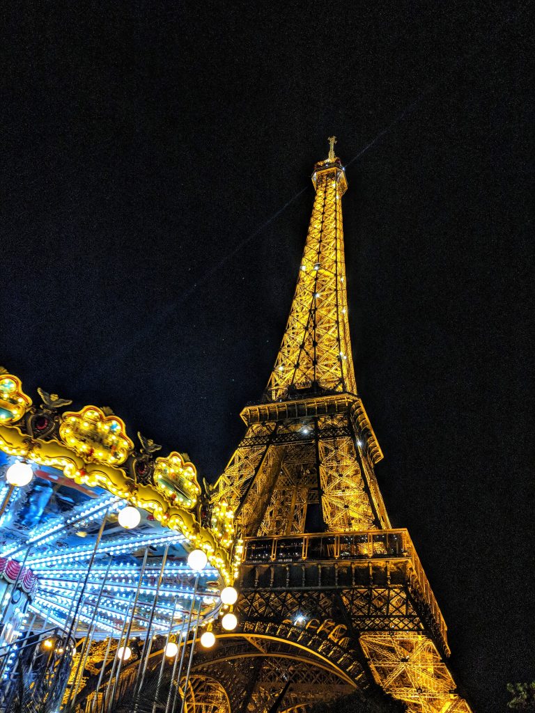 Eiffel Tower and carousel at night.