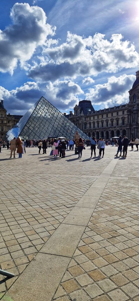 The Louvre with a crowd of people in the background.