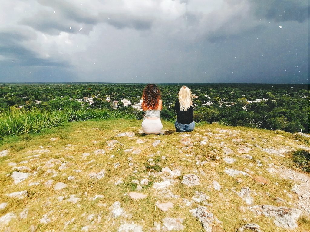 Amy & a friend that she met in Mexico using a rock to steady her phone and set on a timer. They are overlooking some Mayan ruins with a thunderstorm on it's way in the distance.