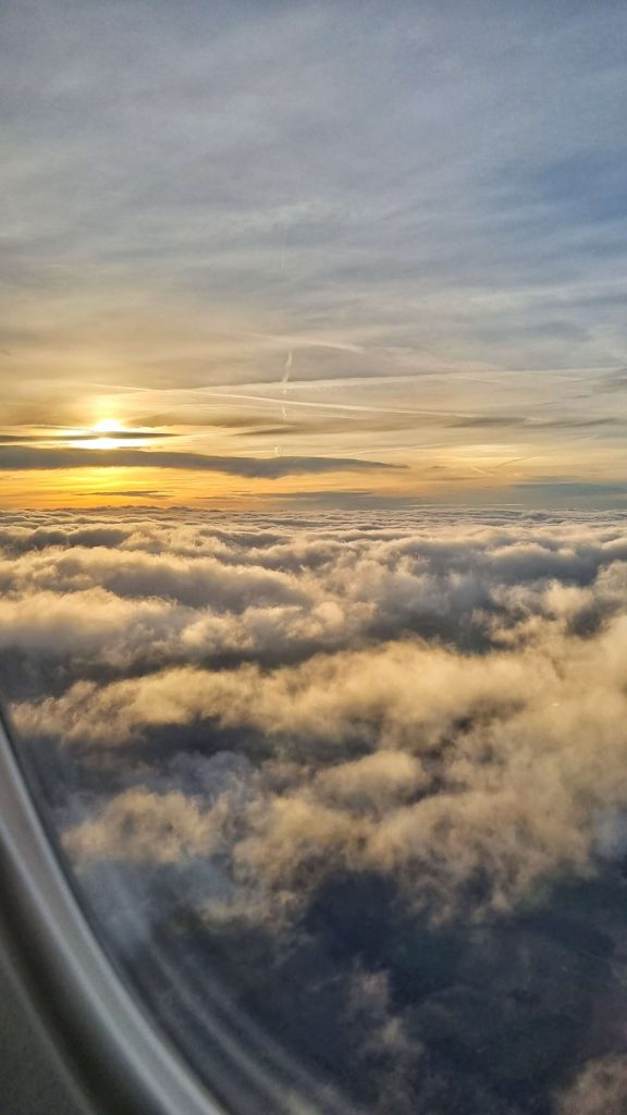 Photo from the airplane when we were on the way to NYC. The sun is shining beautifully over the clouds.