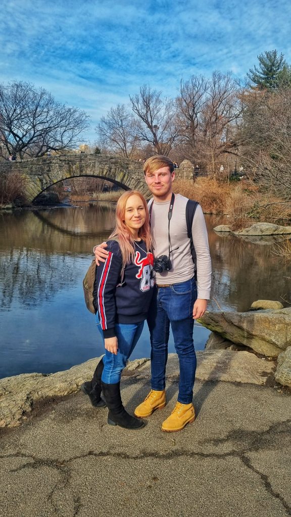 Amy and Liam standing in front of one of the beautiful bridges in Central Park.