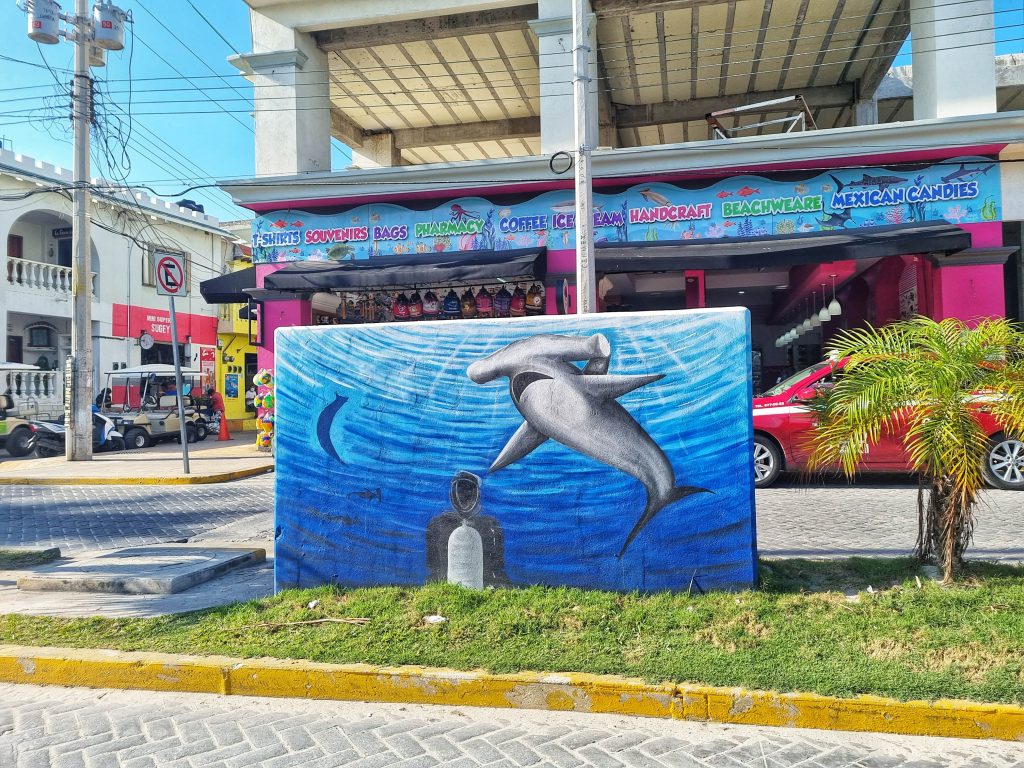 Street art of a hammerhead shark and a scuba diving in Isla Mujeres.