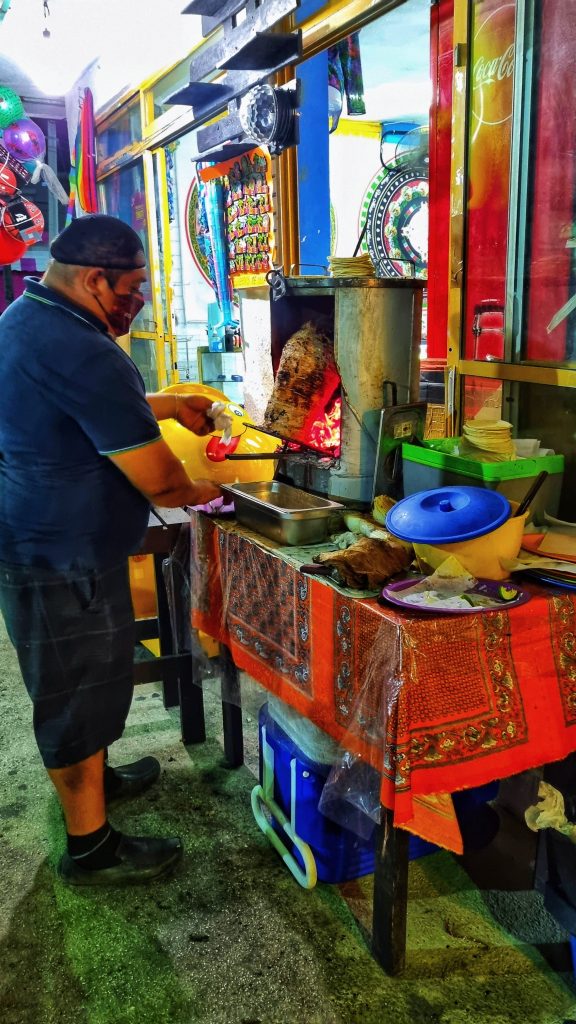 Some of the best tacos in Isla Mujeres is at Taqueria Mafia. This image shows them preparing the delicious tacos so if you're wondering is Isla Mujeres worth visiting then going for the tacos alone is the best reason.