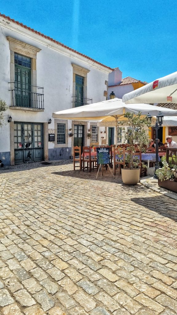 The Old Tavern, one of our favourite restaurants in Faro. You can see the beautiful cobblestones that make up Faro and then the tables outside for the Old Tavern.