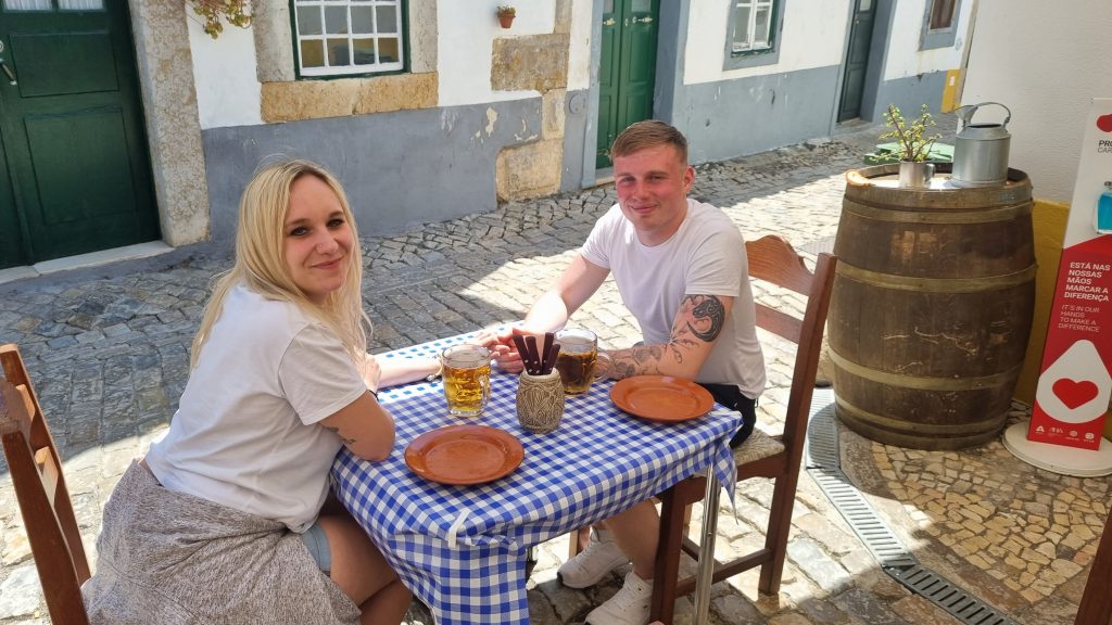 Amy & Liam waiting for their tapas at the Old Tavern Faro and enjoying a pint of Sagres after their flight coming into Faro.