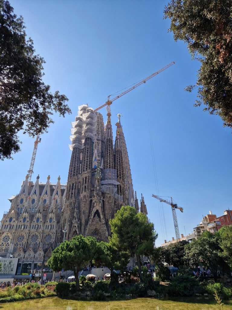 Sagrada Familia with the garden greenery nearby.