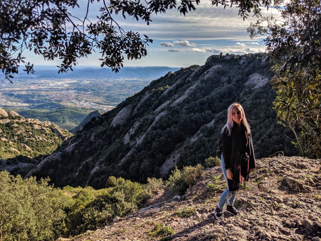 Amy standing with the view of Catalonia behind her at Montserrat.